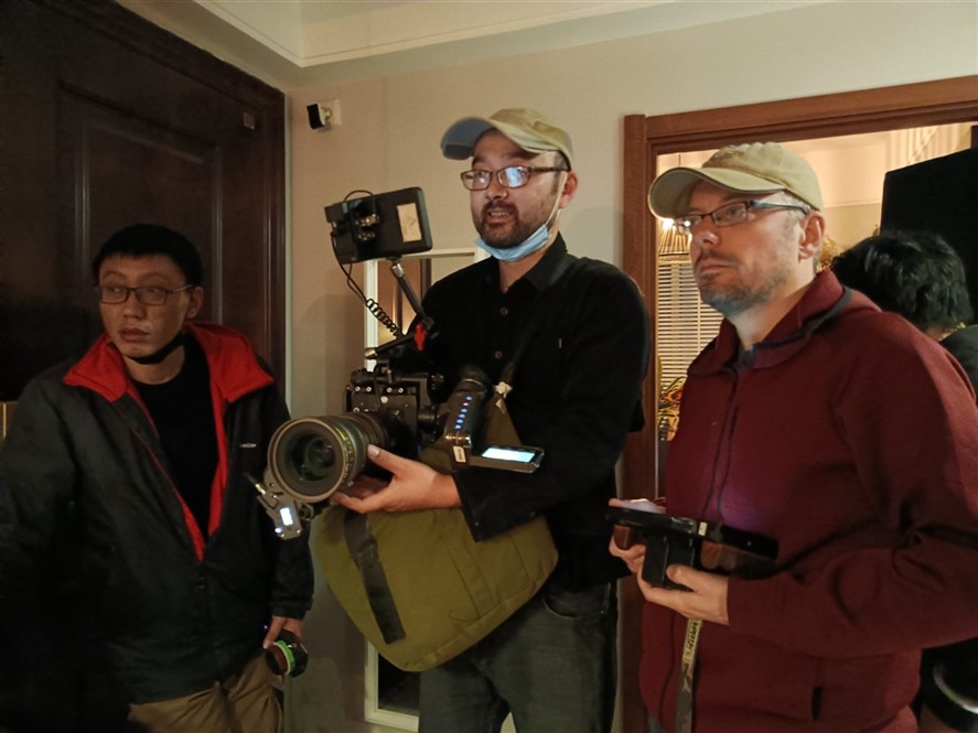 Ningbo production crew reviewing a shoot on location
